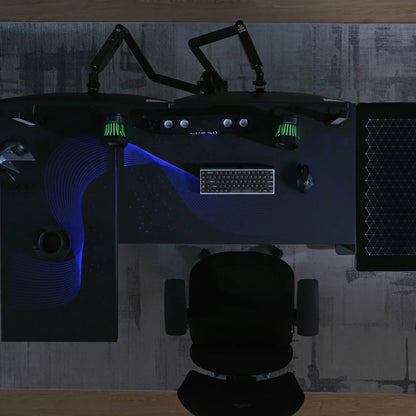 Modern gaming command center featuring the Eureka Ergonomic L-shaped glass desk with a dual monitor setup.
