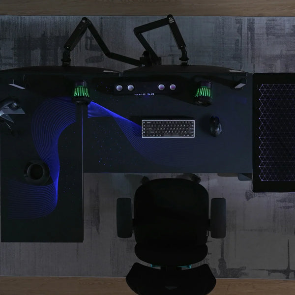 Modern gaming command center featuring the Eureka Ergonomic L-shaped glass desk with a dual monitor setup.