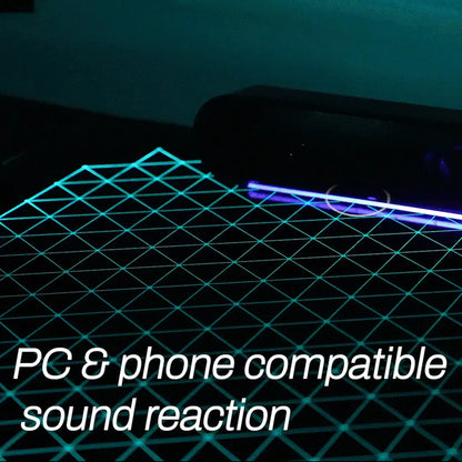 Close-up view of the premium tempered glass surface and integrated RGB light strips on the Eureka Ergonomic desk.